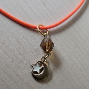 Goldtone and Orange Star and Moon Pendant Necklace